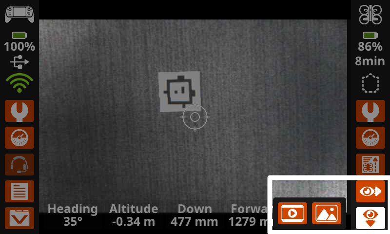 The Controller screen showing a downward camera view in the main display, with the Eye buttons in the lower right corner highlighted, showing the options for capturing images from the downward Vision Sensor.