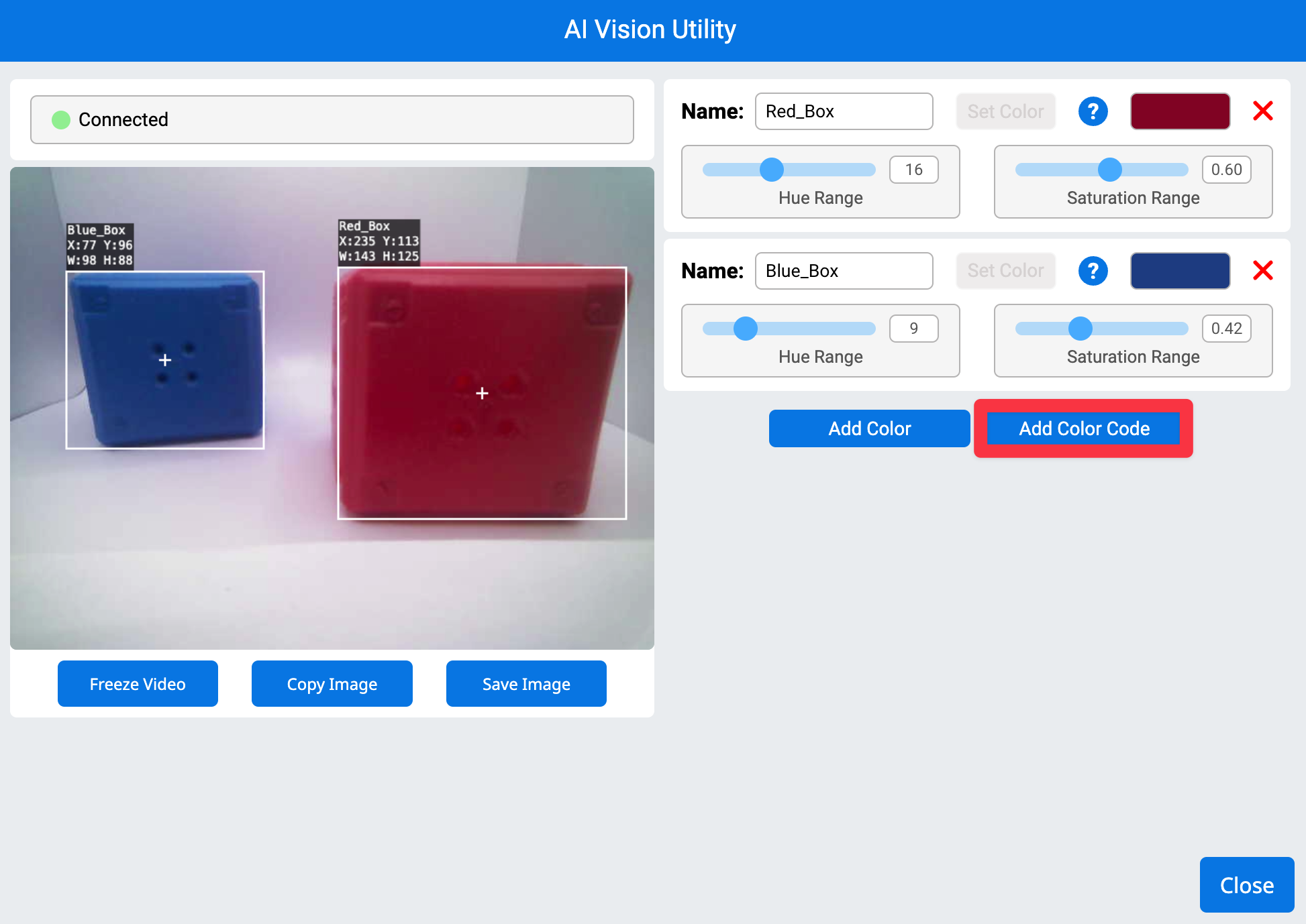 Utilidad de visión de IA en VEXcode AIM. A la izquierda se muestra la señal de la cámara del robot con un cubo azul y otro rojo. A la derecha se resalta el botón "Añadir código de color".