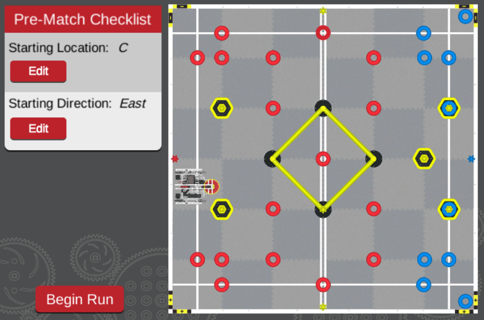 A robotics competition field with a pre-match checklist on the left side of the screen. The checklist displays the starting location as "C" and the starting direction as "East," with options to edit both settings. The "Begin Run" button at the bottom left is ready to be pressed to start the match.