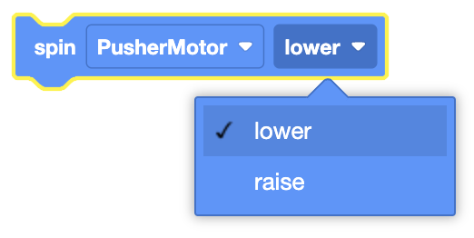 The image displays a visual coding block where the "spin" command is applied to the "PusherMotor." The direction for the spin is currently set to "lower," with an option in the dropdown menu to switch to "raise."