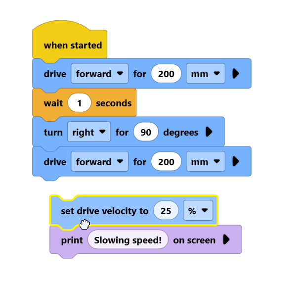 Screenshot of a set drive velocity to 25% block and its attached print block being dragged together as a group.