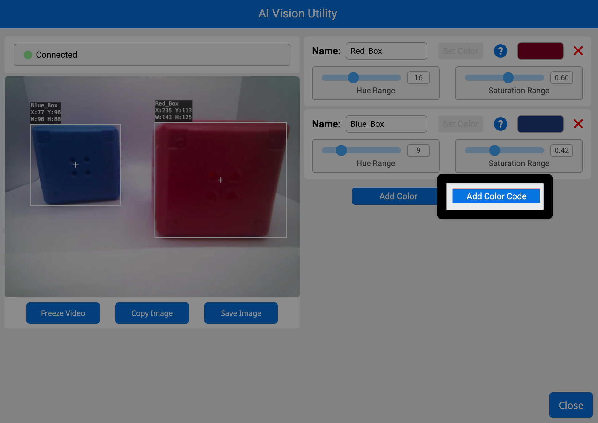 A screenshot of the AI Vision Utility in VEXcode AIM. The left shows the camera feed from the robot with one blue cube and one red cube. The right has a highlight on the Add Color Code button, in the center to the right of the Add Color button.